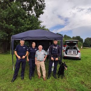 Dwóch policjantów, policjantka i prezes stowarzyszenia przed namiotem